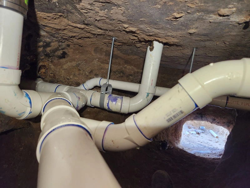 Plumber installing water heater in bathroom